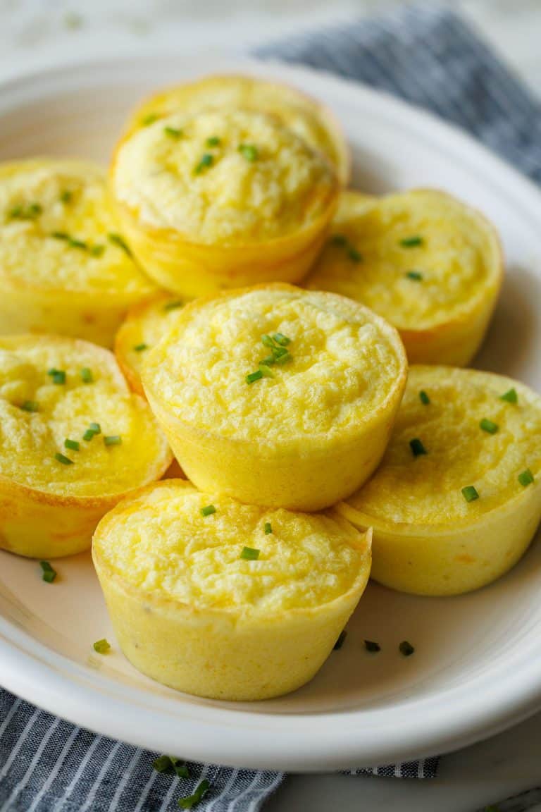 Cottage Cheese egg bites recipe stacked on a white plate with chives on top