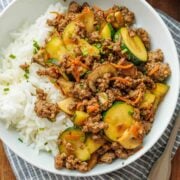 ground beef stir fry recipe with mushrooms, zucchini and carrots served over rice.