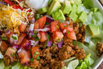 Taco Salad served with toppings in a white bowl