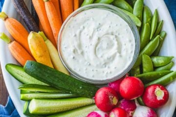Vegetable platter with Ranch dip on a blue towel