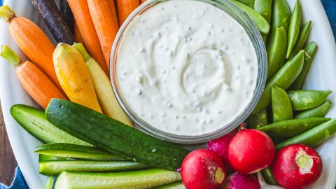 Vegetable platter with Ranch dip on a blue towel