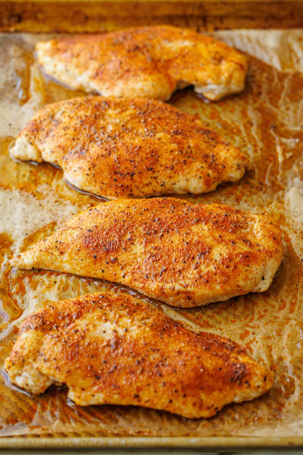 Baked chicken breasts on a baking sheet