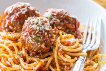 Spaghetti and meatballs served with a fork