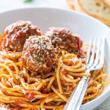 Spaghetti and meatballs served with a fork