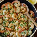 Shrimp Scampi stirred in a saute pan with parsley