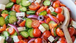 Greek Salad recipe with the best Greek Salad dressing in a a white bowl