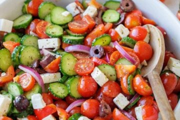 Greek Salad recipe with the best Greek Salad dressing in a a white bowl