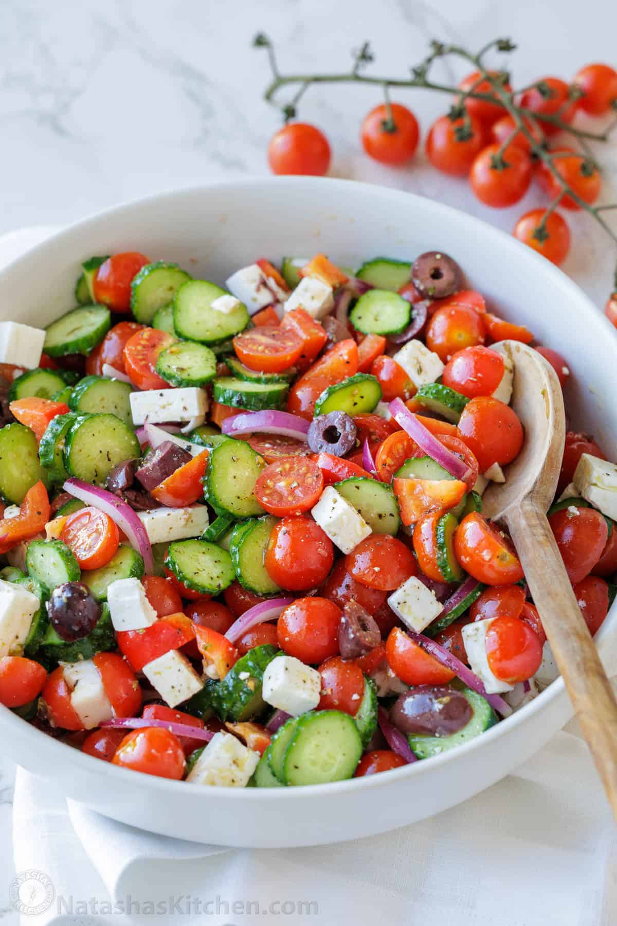 Greek Salad recipe with the best Greek Salad dressing in a a white bowl