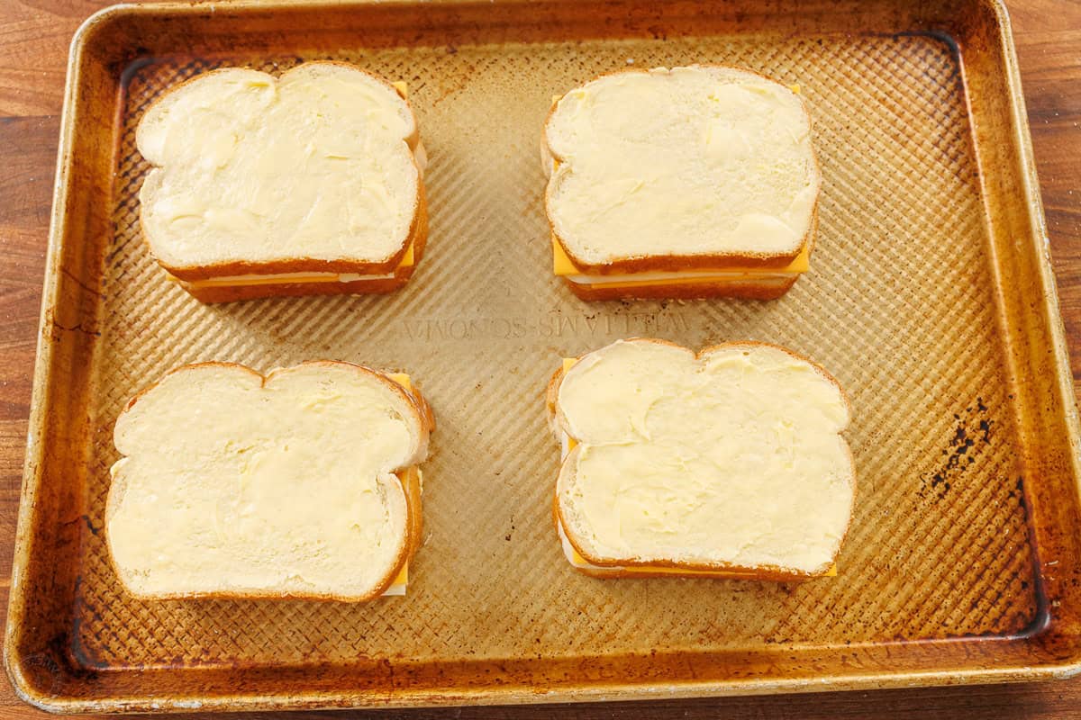 butter on the crust is the secret to the best grilled cheese in the oven