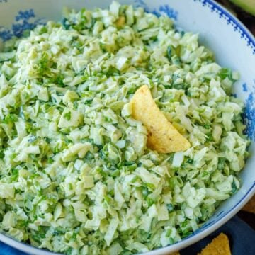 Green Goddess Salad in a bowl with corn chips around