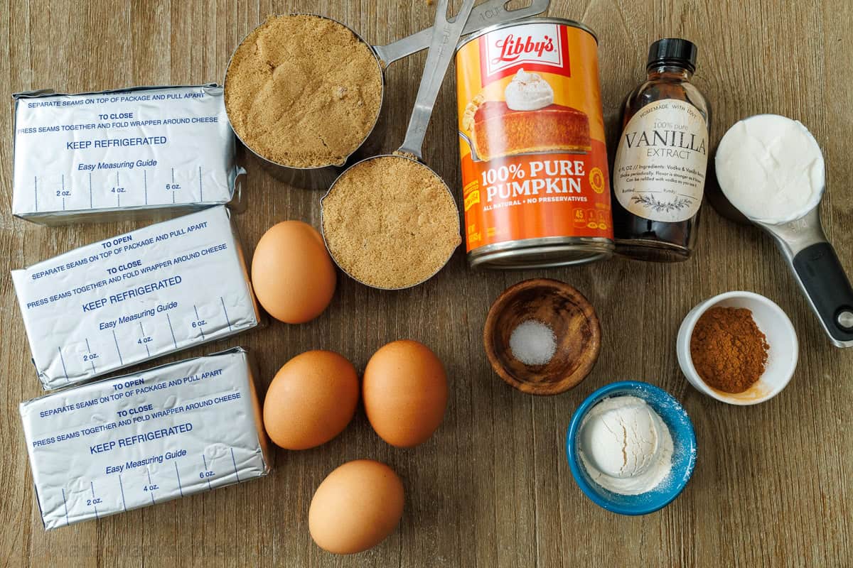 My pumpkin cheesecake recipe is so easy to make and is better than any professional baker! Save money and make your Holiday dessert at home! Ingredients for easy Thanksgiving dessert including cream cheese, eggs, brown sugar, graham crackers, canned pure, vanilla extract, salt, cinnamon, sour cream and flour