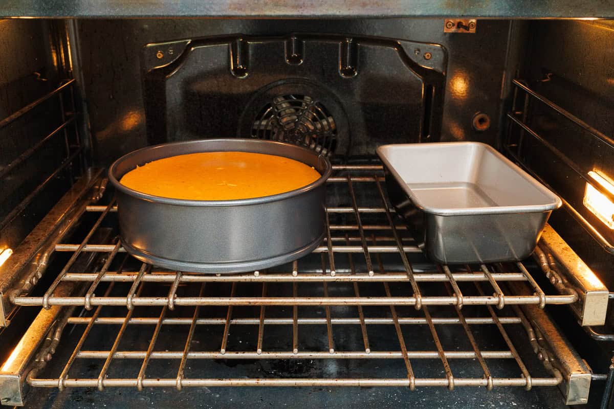 My pumpkin cheesecake recipe is so easy to make and is better than any professional baker! Save money and make your Holiday dessert at home! How to bake pumpkin cheesecake so it won't crack using a loaf pan of water in the oven