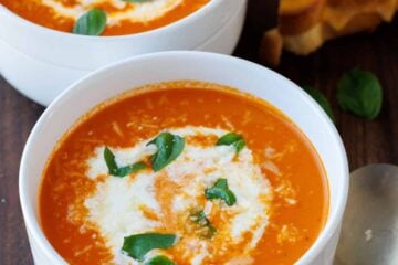 Two bowls of Roasted Tomato soup recipe with Grilled Cheese and a spoon
