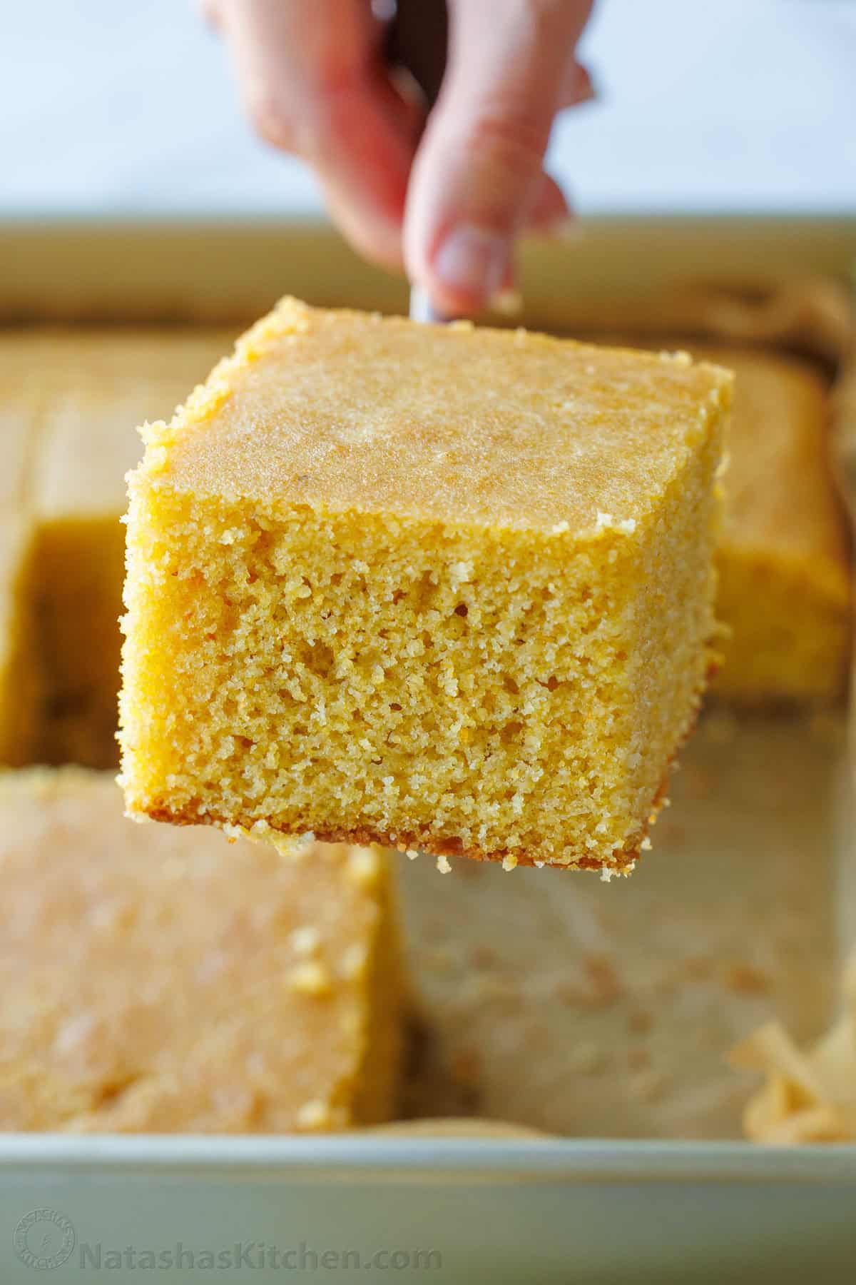 The best homemade cornbread recipe is easy to make with pantry staples. Serve with your favorite holiday or BBQ menu and honey butter on top. best homemade Cornbread recipe cut from a full pan