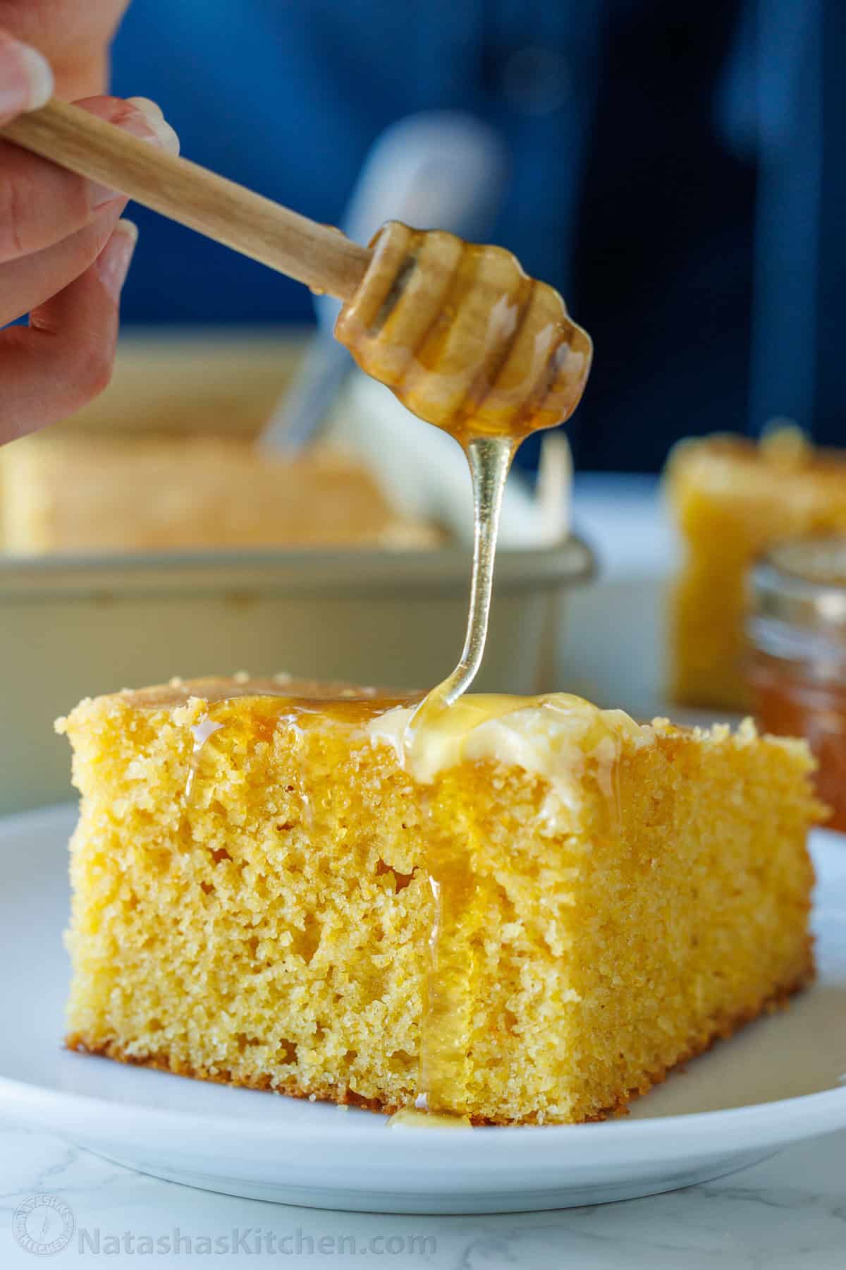 The best homemade cornbread recipe is easy to make with pantry staples. Serve with your favorite holiday or BBQ menu and honey butter on top. drizzling honey on homemade cornbread recipe