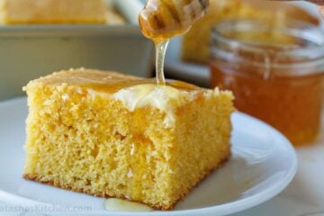 honey and butter on top of best cornbread recipe on a white plate