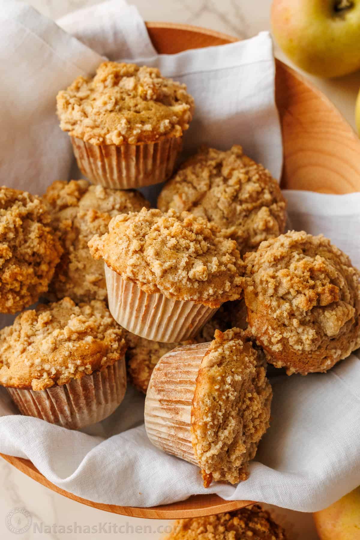 Bakery-style Apple muffins with crumb topping are so easy to make, with a moist crumb and chunks of apple inside. Uses just pantry staples. Bowl of apple muffins with crumb topping