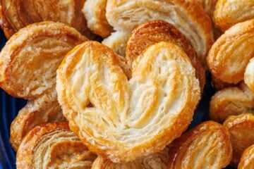 Blue plate with palmiers cookies piled on top