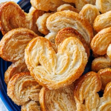 Blue plate with palmiers cookies piled on top