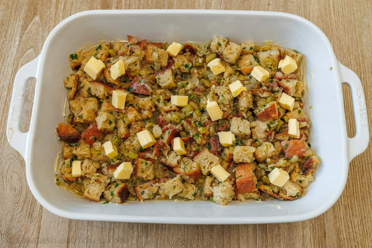 Butter chunks spread over bread pieces to make the best stuffing recipe