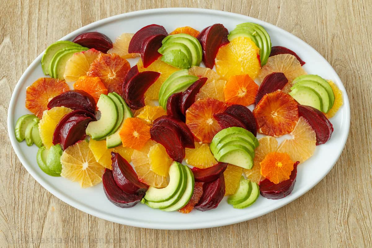 Easy citrus salad on an oval plate with grapefruit, orange, tangerine, beets, and avocado
