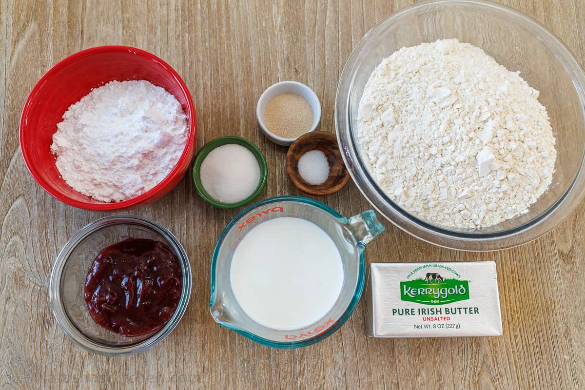ingredients for traditional jewish cookies including flour, yeast, salt, butter, whole milk, sugar, jam and confectioners sugar