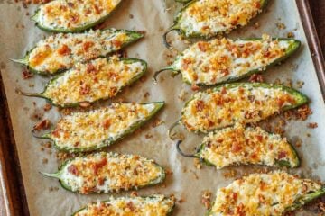 tray of spicy appetizers with crispy bacon topping and stuffed peppers