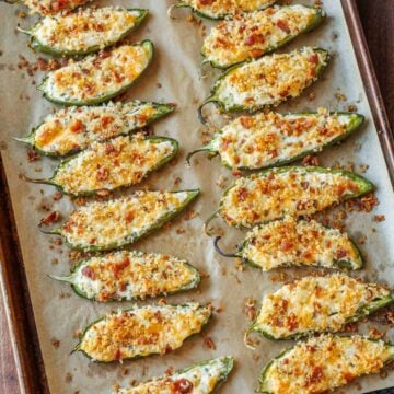 tray of spicy appetizers with crispy bacon topping and stuffed peppers