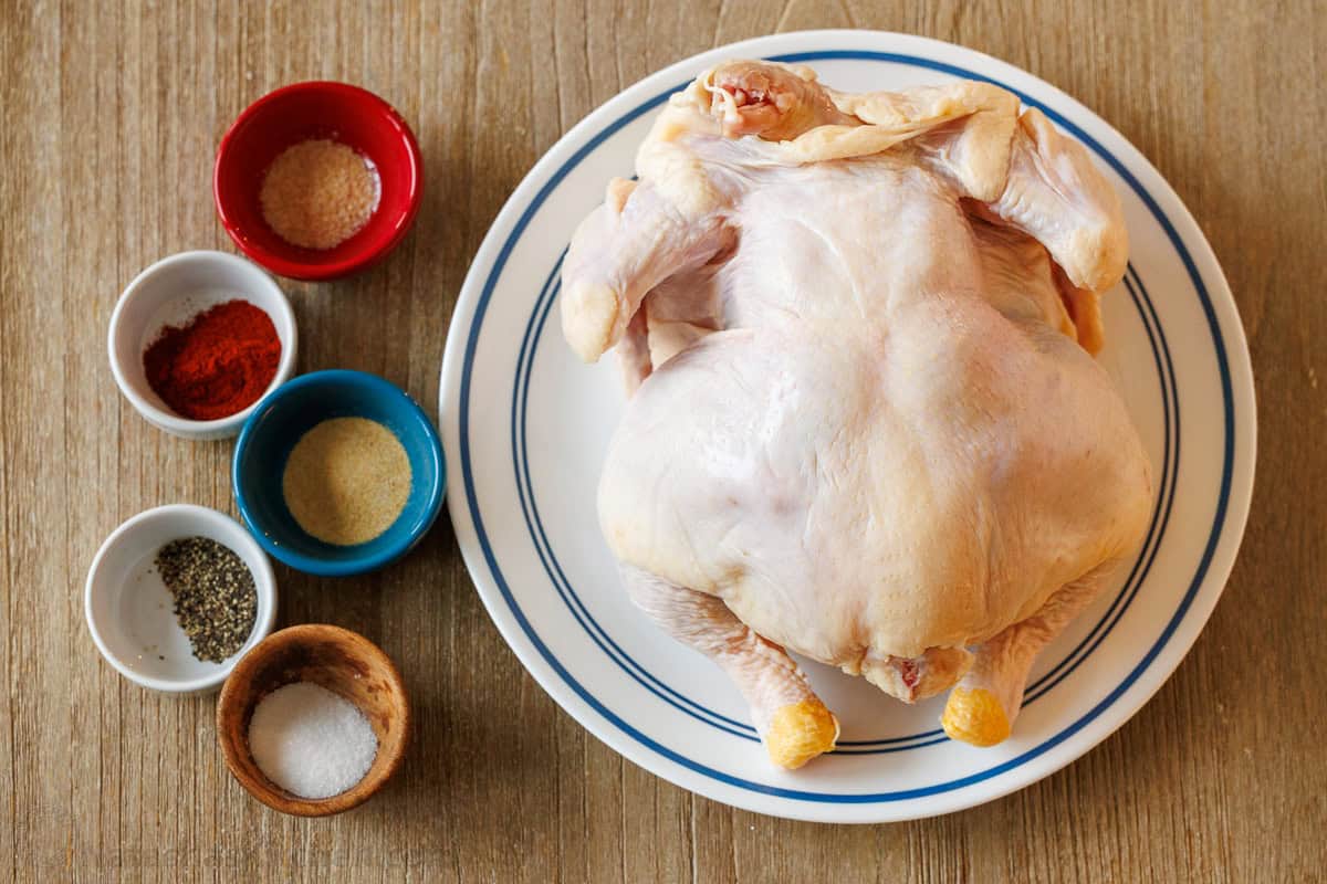 My Air Fryer Whole Chicken Recipe perfectly cooks a 3.5-5.5 pound bird with crispy skin and juicy meat. It's easy and perfectly seasoned. Ingredients for air fryer whole chicken recipe including a raw chicken and spice rub