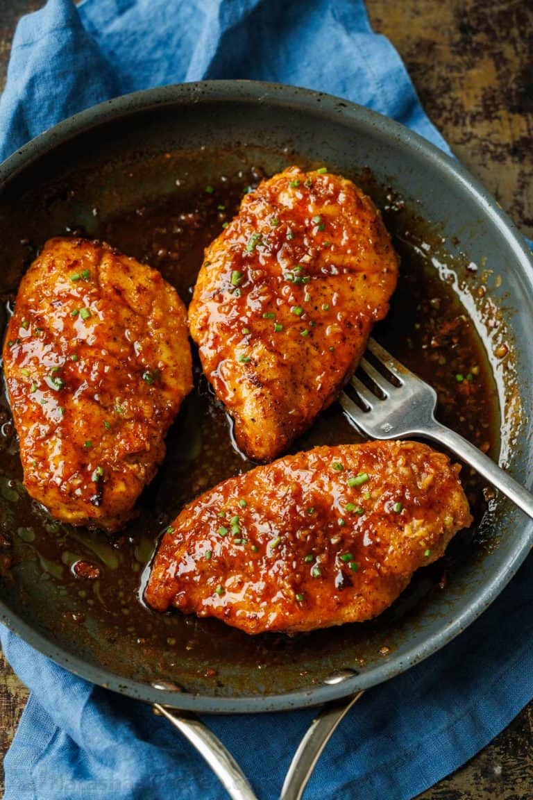 Honey glazed chickenhearted  successful  a saute cookware  garnished with greenish  onions.