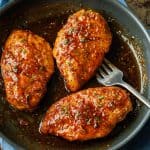 Honey glazed chicken breast recipe in a saute pan with a fork to serve