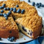 blueberry coffee cake with crumb topping and fresh blueberries on top