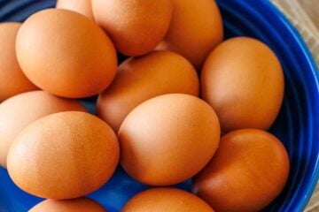 large plate of brown eggs on a blue plate