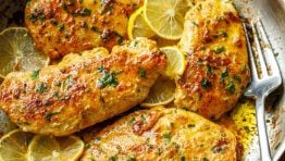 Lemon pepper chicken recipe cooked in a skillet with a fork for serving