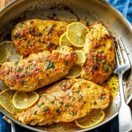 Lemon pepper chicken recipe cooked in a skillet with a fork for serving