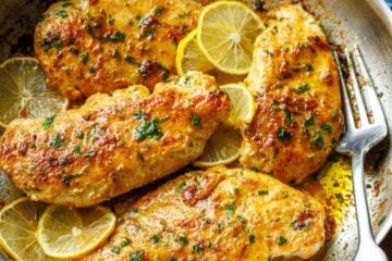Lemon pepper chicken recipe cooked in a skillet with a fork for serving