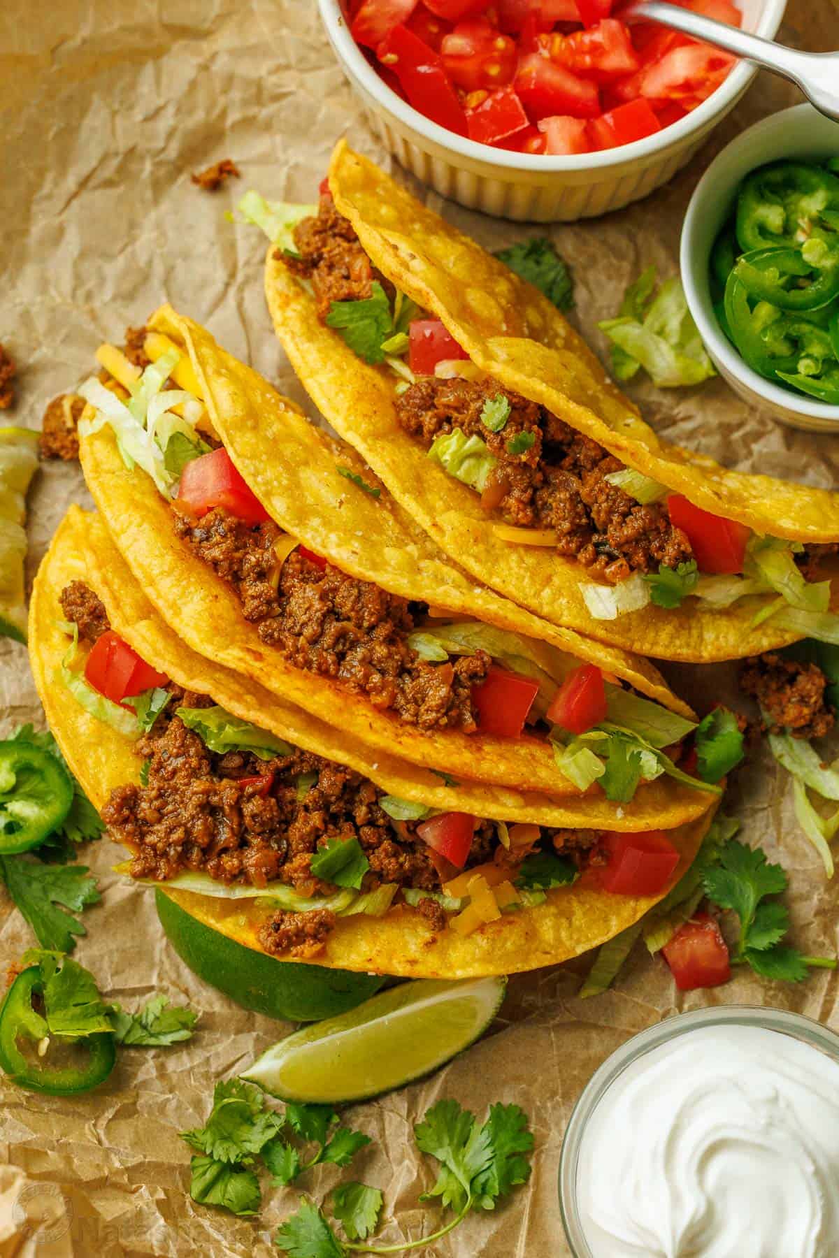 Crunchy ground beef tacos with fresh toppings and cilantro