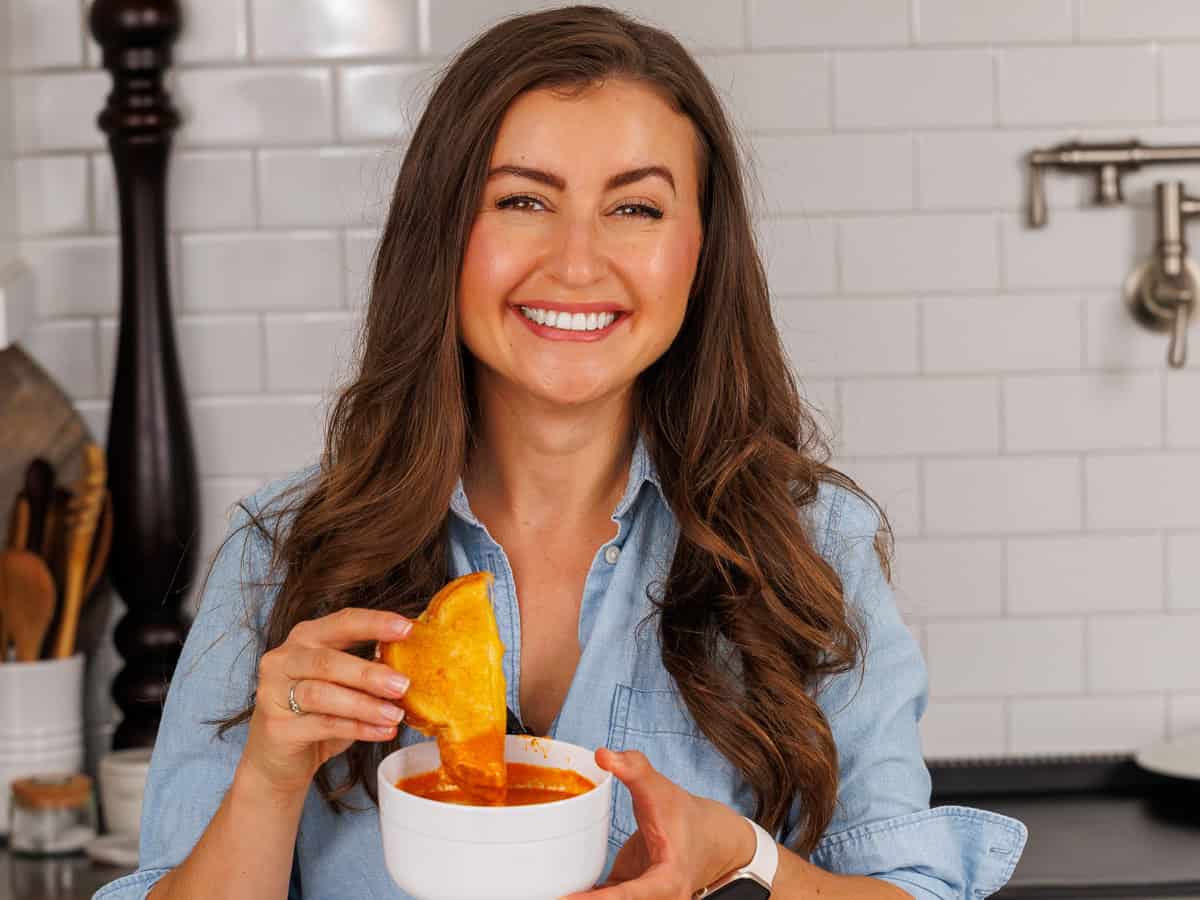 Natasha dipping a sandwich into a homemade soup