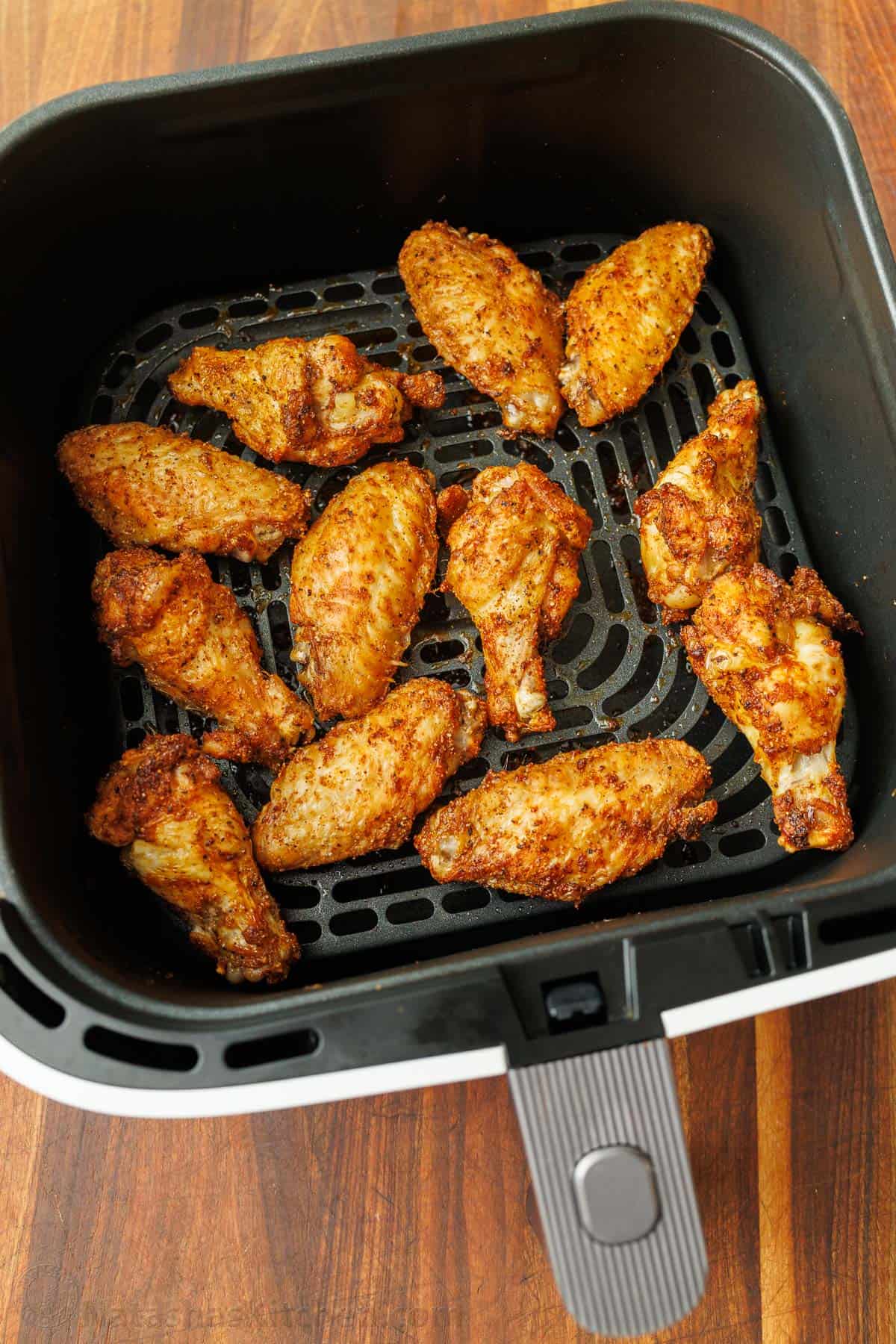 Crispy air fried chicken wings in air fryer basket