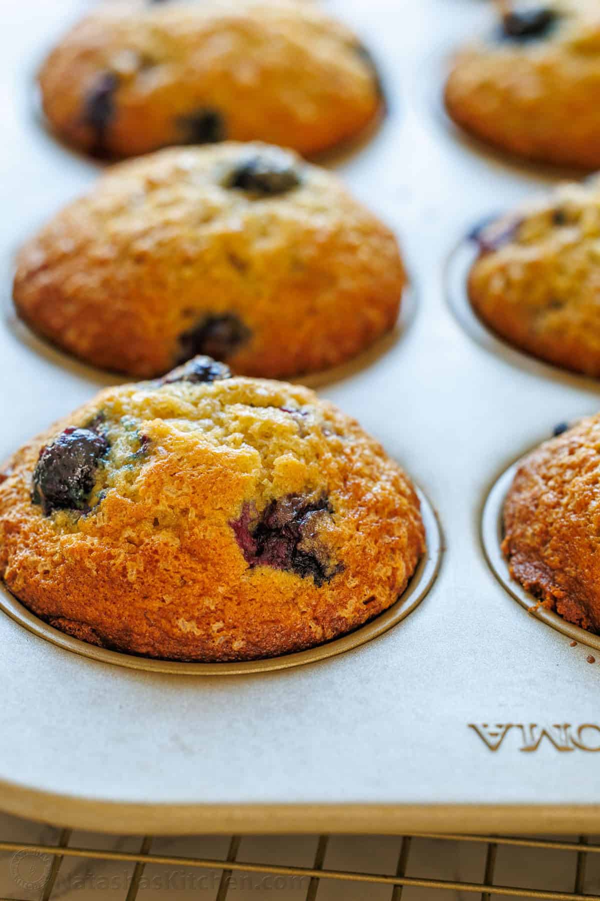 Easy Blueberry Banana Muffins bake up moist, tall, domed, and fluffy with great banana flavor and plenty of juicy blueberries. Large muffin tins with blueberry banana muffin recipe