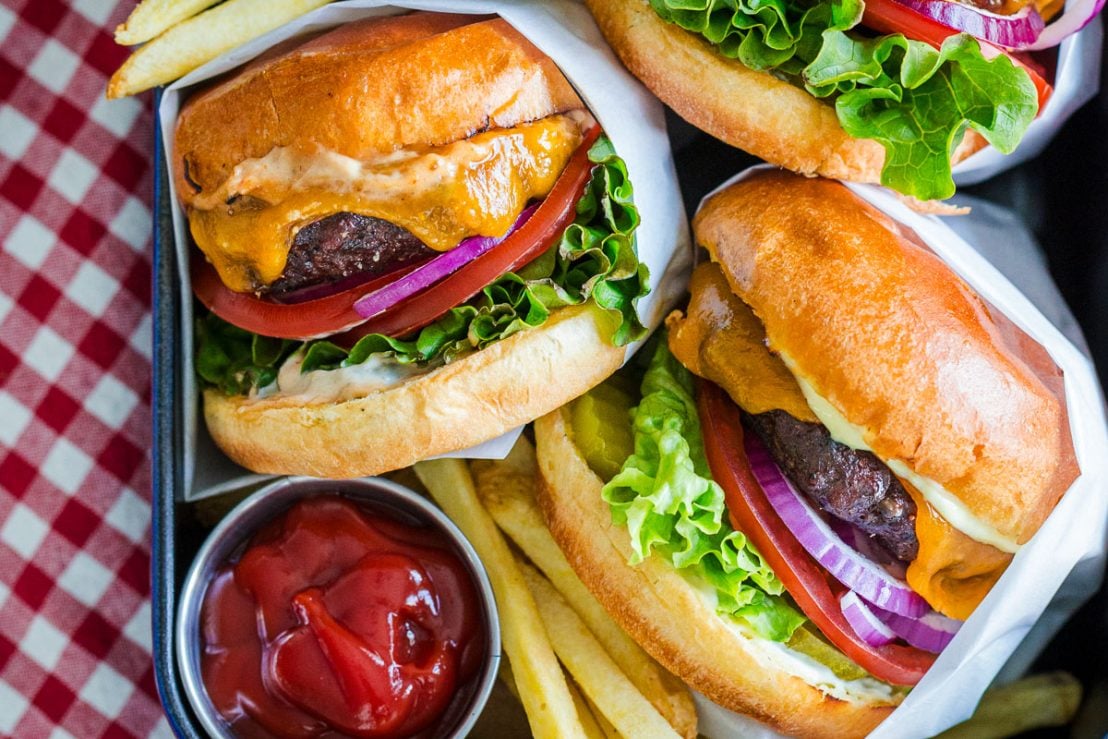 Juicy homemade burger recipe served with fries and ketchup