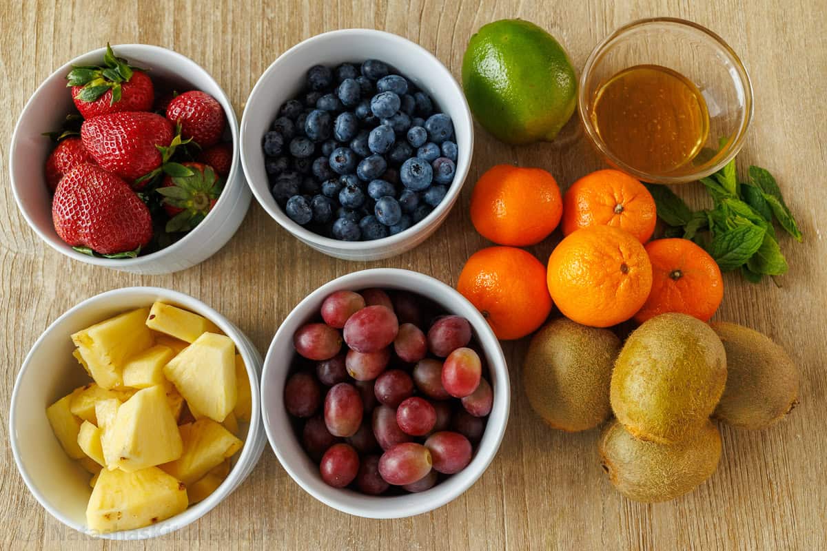 citrus and berries in separate bowls with honey lime dressing