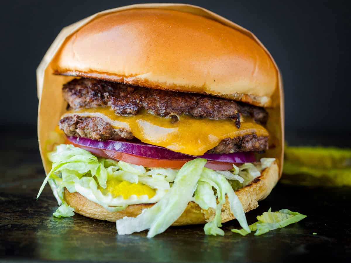 smash burger served on a bun with toppings