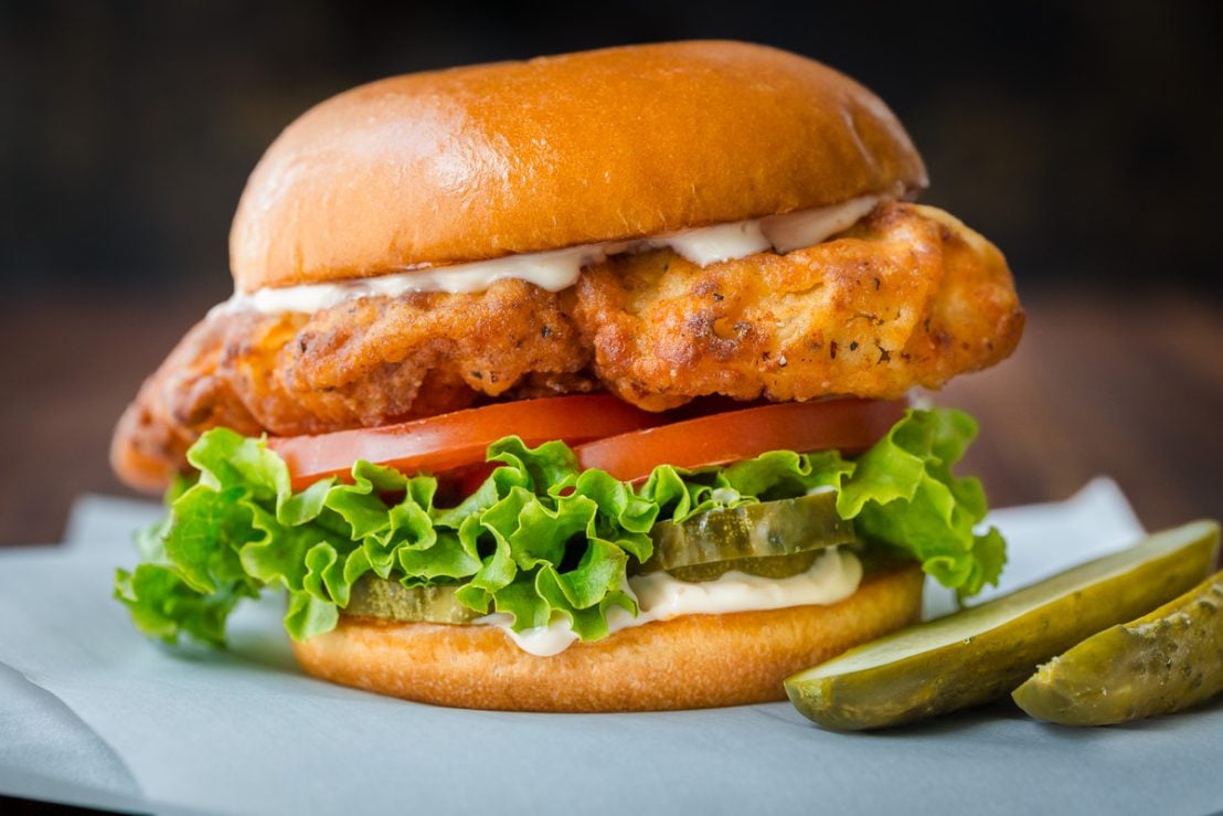 homemade crispy chicken sandwich served on a bun with toppings