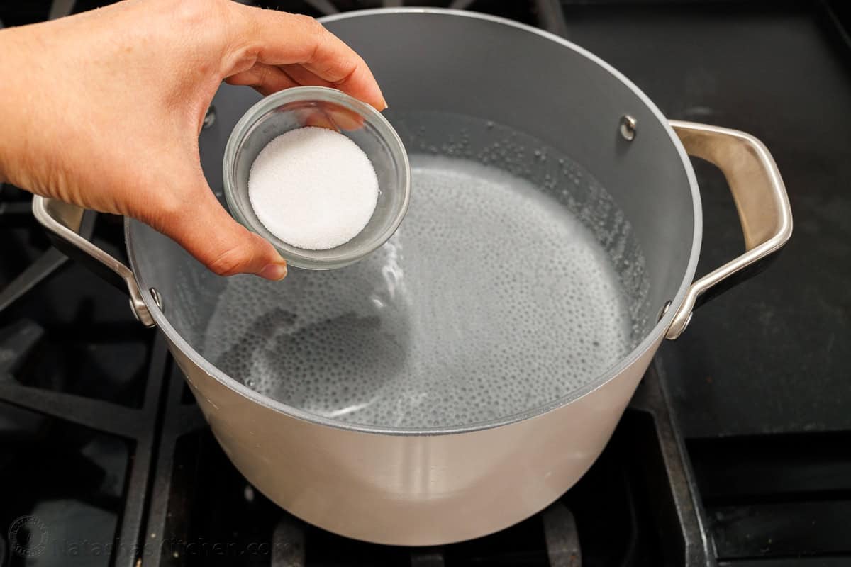 Salt over a pot of boiling water for making salted water