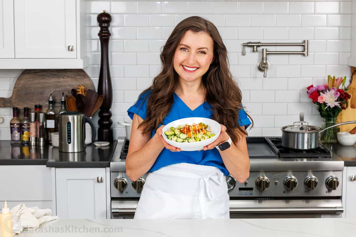 Natasha's Kitchen Salmon Bowls in a white dish with white sauce drizzled over the top