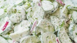 Creamy cucumber salad recipe garnished with dill