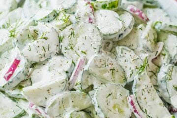 Creamy cucumber salad recipe garnished with dill