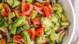 Cucumber Tomato Avocado Salad in white serving bowl