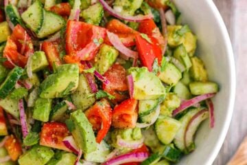 Cucumber Tomato Avocado Salad in white serving bowl